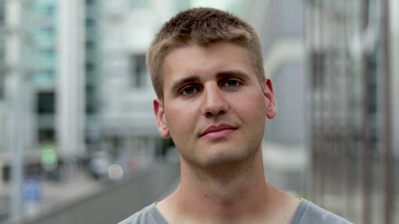 예쁜 젊은 남자가 카메라를 보고 있습니다.