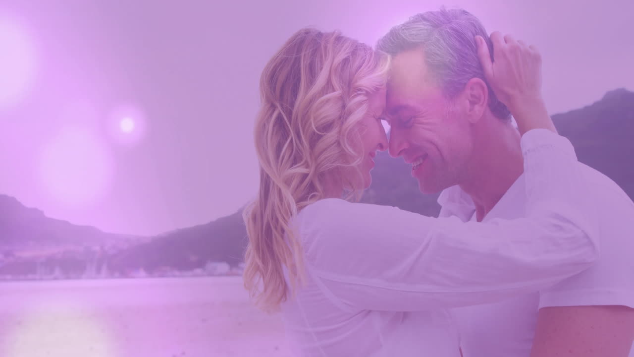 Animation of light spots over caucasian couple embracing