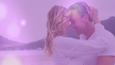 animation of light spots over caucasian couple embracing