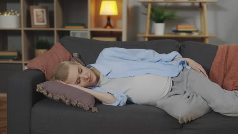 pregnant woman sleeping on couch