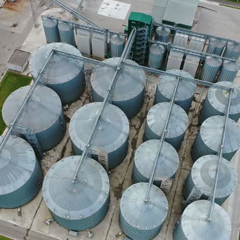 metal containers for grain storage. modern grain silos elevator on field. agricultural granary for farming industry. top view.