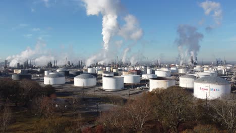 rising aerial over a huge oil refinery along the mississippi river in louisiana suggests industry, industrial, pollution