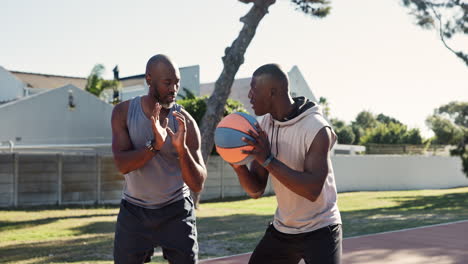 father and son playing basketball outdoors