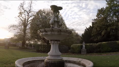 slow motion loop of a fountain with water dripping at sunset