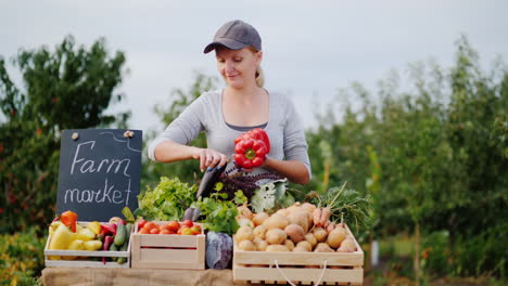 young female farmer is laying vegetables on the counter of a farmers market