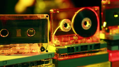 vintage cassette tapes on display in a colorful store front or retro dj setup - sliding view with blurred background motion