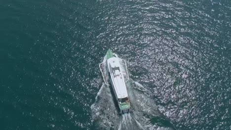 Aerial-view-of-public-transportation-ferry-travelling-on-the-lake-garda-in-Riva-Del-Garda,-a-small-town-and-commune-in-the-Italian-province-of-Trento-at-the-northern-tip-of-the-lake