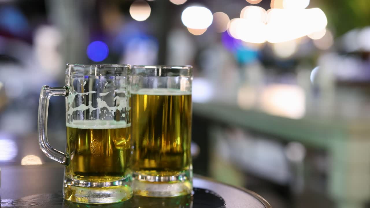 vasos de cerveza en una calle nocturna bulliciosa