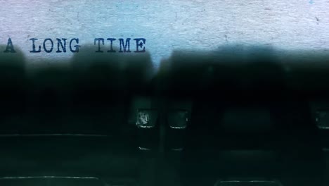 A long time ago word closeup being typing and centered on a sheet of paper on old vintage typewriter