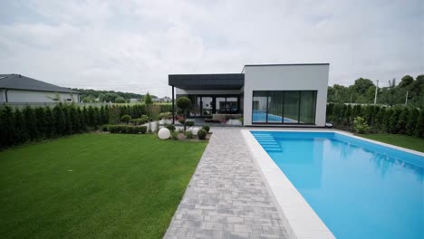 modern exterior of the house. house with its own territory and large panoramic windows. a small suburban house in a modern style.