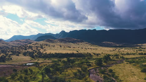 gorgeous hyperlapse of heavy clouds accumulating high over the mountain range and the forest