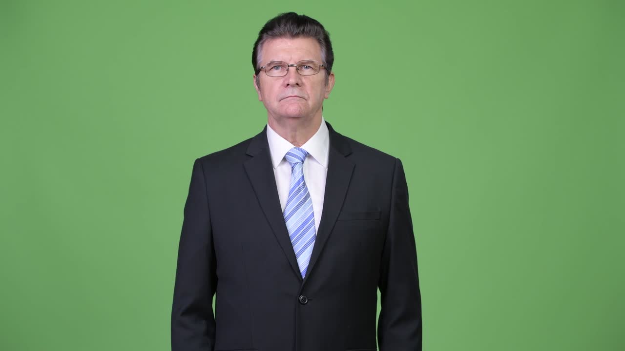 Senior handsome businessman looking concerned