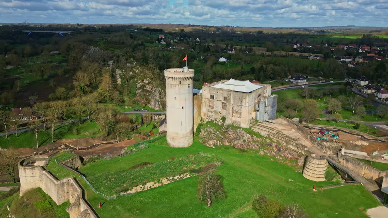 Historic Château de Falaise, birthplace of William the Conqueror, surrounded by lush trees, Normandy, France, Medieval landmark. Aerial forward