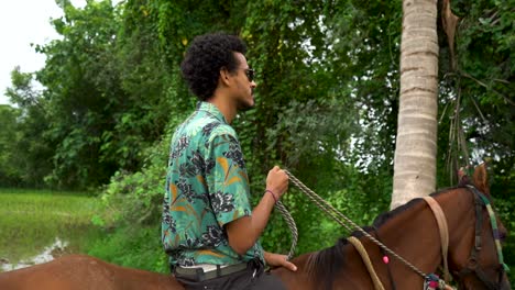 Young-handsome-man-with-brown-horse