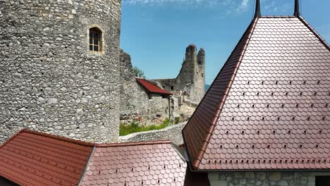 aerial drone fly above old žovnek castle in braslovče slovenia restored ruins, slow motion shot of historical building