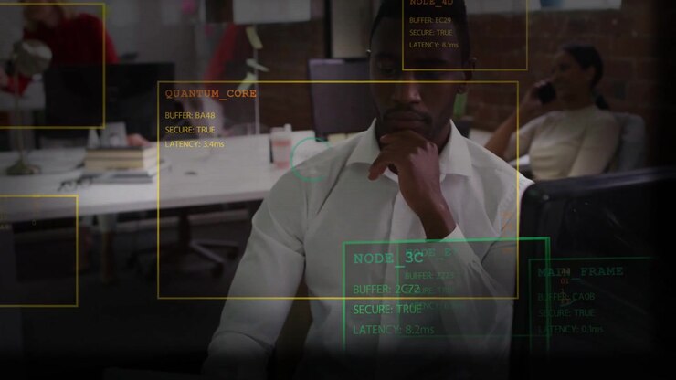 Man at desk responding to tech HUD readouts, raising hand to chin and analyzing QUANTUM_CORE data