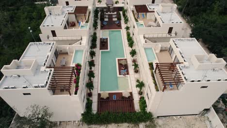 Drone-shot-of-a-luxury-hotel-with-beautiful-modern-architecture-in-Tulum,-Mexico