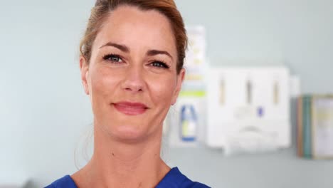 Smiling-beautiful-nurse-putting-surgical-gloves