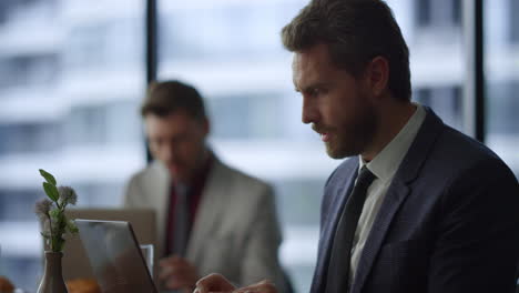 focused professional man working on laptop