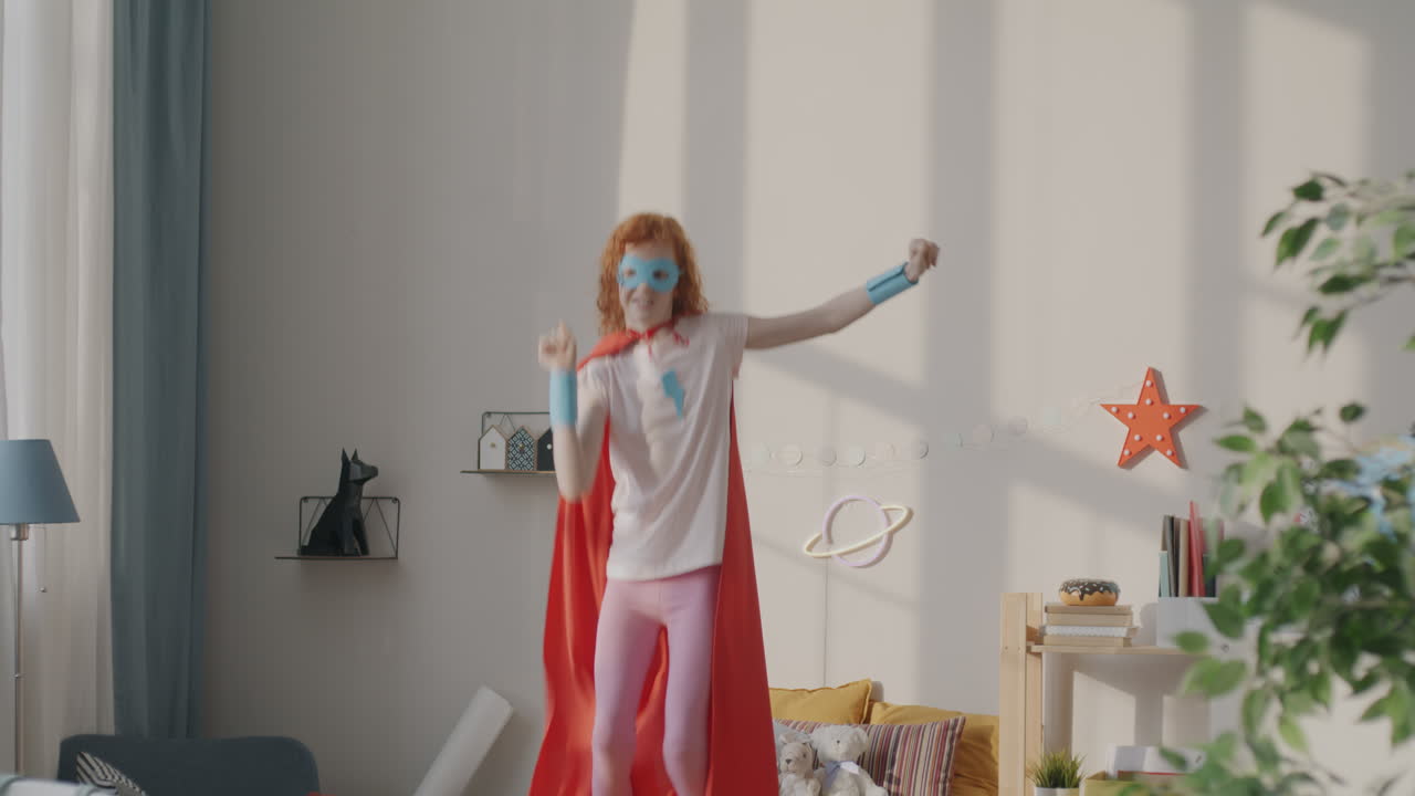 Girl Dressed as Superhero Jumping in a Bedroom