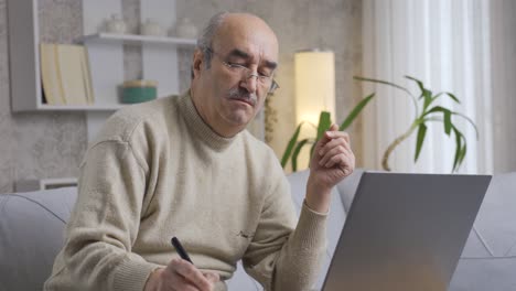 Stressed-and-thoughtful-Old-Man-doing-business-on-computer.