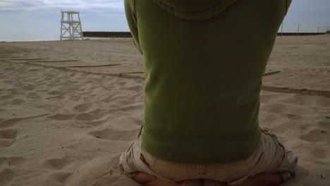 professional photographer taking photo of couple on beach. panning from man feet