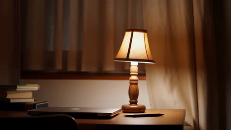 cozy desk scene with warm table lamp and laptop