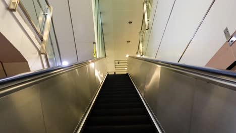 ascending escalator in a bangkok subway station