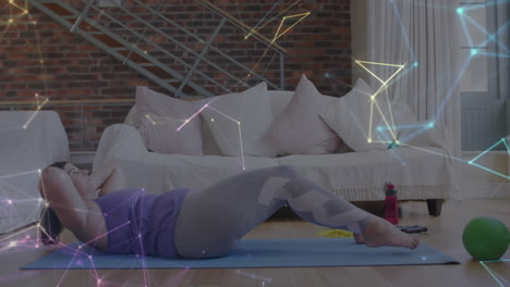 glowing network of connections against caucasian woman performing crunches exercise at home