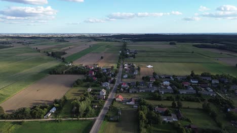 summertime in szumsk, a village in central poland, with cereal farming fields and traditional houses