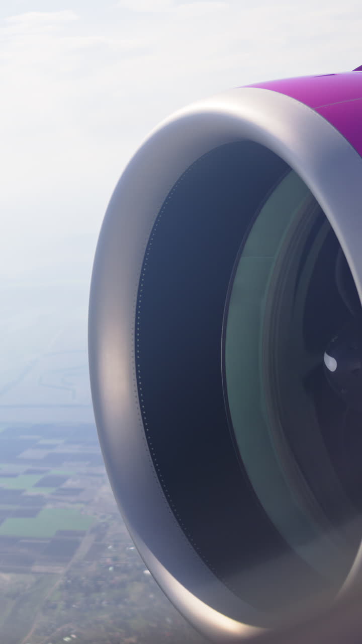 View of a turbine rotating from an airplane window. Vertical