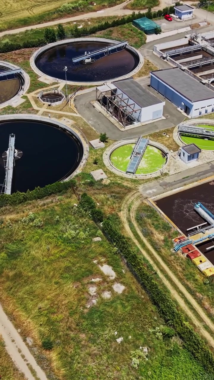 Water treatment plant in operation near agricultural fields during daytime