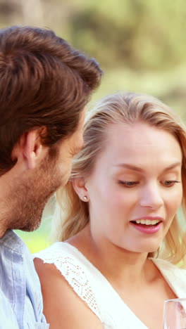 happy couple discussing and holding a red wine glass