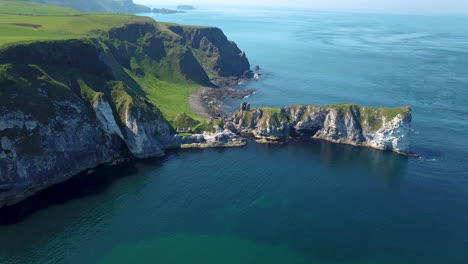 Kinbane-Castle-in-County-Antrim,-Northern-Ireland,-on-a-long,-narrow-limestone-headland-projecting-into-the-sea,-beautiful-aerial-shot