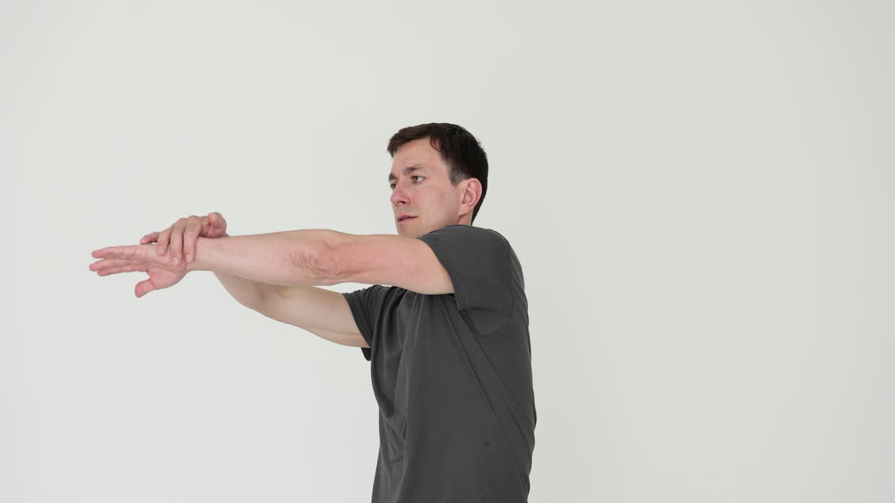 Man stretching his arms indoors