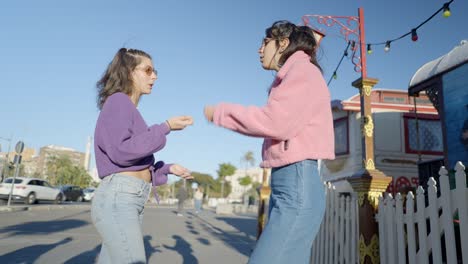 two teen girls dancing on the street