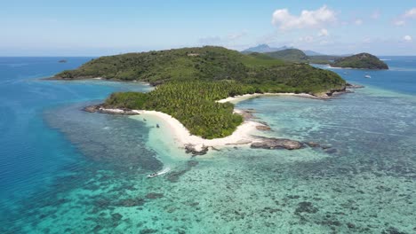 Aerial-view-of-Drawaqa-island,-crystal-clear-waters-of-Pacific-Ocean,-seascape-with-colorful-coral-reefs,-many-shades-of-turquoise-and-blue---landscape-panorama-of-Yasawa-islands-from-above,-Fiji