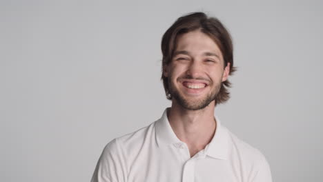 Caucasian-man-in-front-of-camera-on-gray-background.