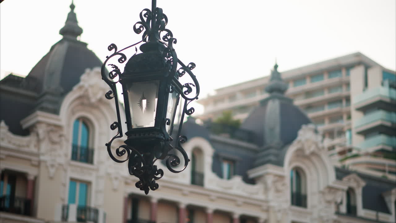 Close up of a street lamp with a blurry building view in Monaco