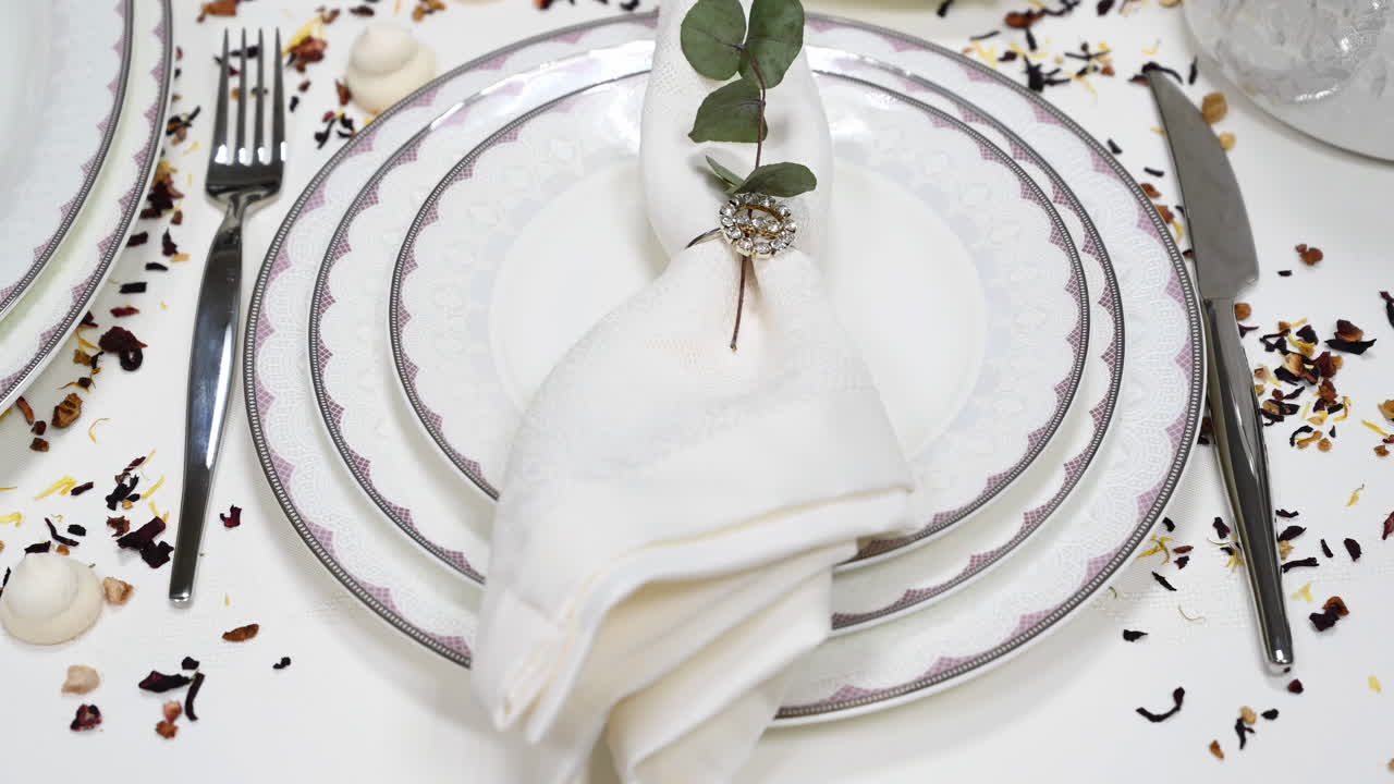 Close up of a nicely folded napkin on a plate on a set table