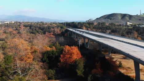 aerial rising shot over unique bridge traffic