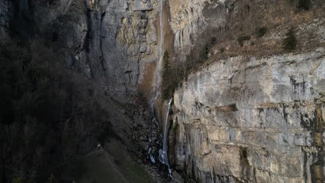 soaring above, behold the majestic allure of rugged mountain landscapes embellished with cascading waterfalls, nestled near walensee unterterzen, switzerland