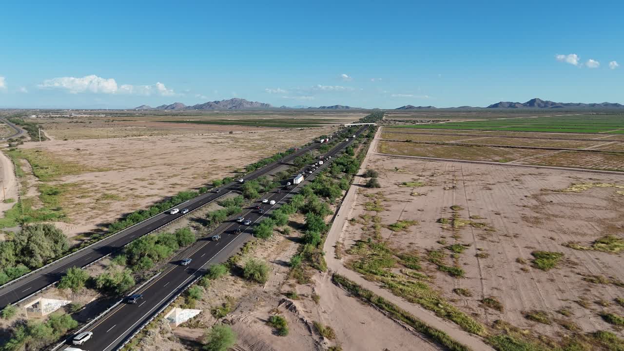 Aerial View of Traffic Jam on Interstate 10 South of Phoenix Arizona, lots of cars backed up, Bright Desert, Blue Skies, Mountains in Background