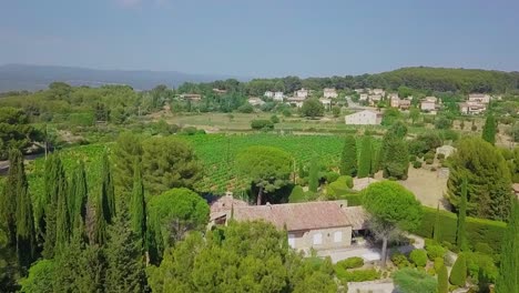 small, quaint village and vineyards in the beautiful countryside of southern france. aerial flyover