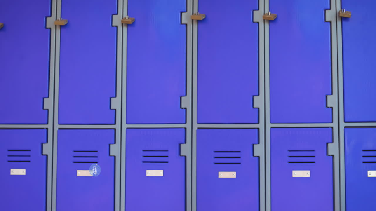 Animation of text welcome back to school and paper plane in blue circle moving over blue lockers