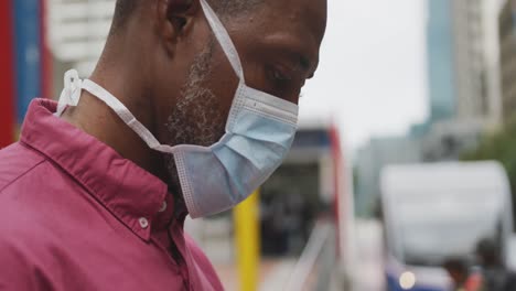 african american man on the go wearing coronavirus covid19 mask
