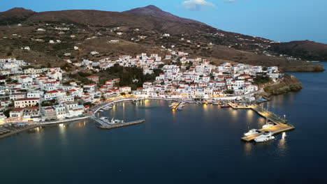 Dusk-aerial-view-of-Batsi,-a-traditional-village-at-the-island-of-Andros,-Cyclades,-Greece