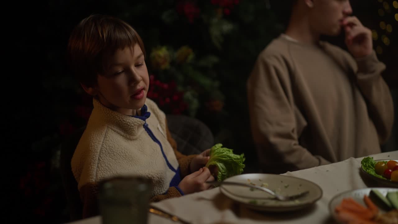 A boy at a family holiday dinner