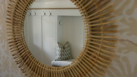 Entryway-bench-with-pillow-seen-through-mirror