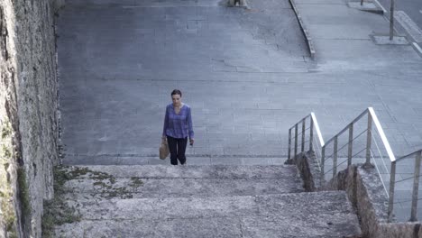 Businesswoman-climbing-up-street-stairs